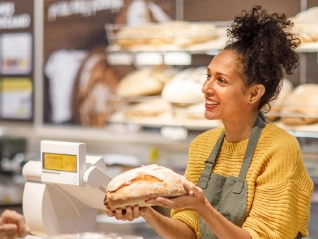 Woman selling bread at a bakery