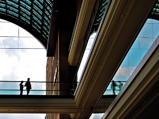 two people standing under an arch of building