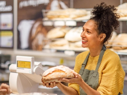 Woman selling bread at a bakery