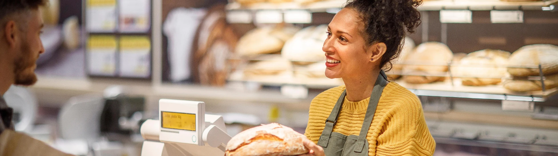 Woman selling bread at a bakery