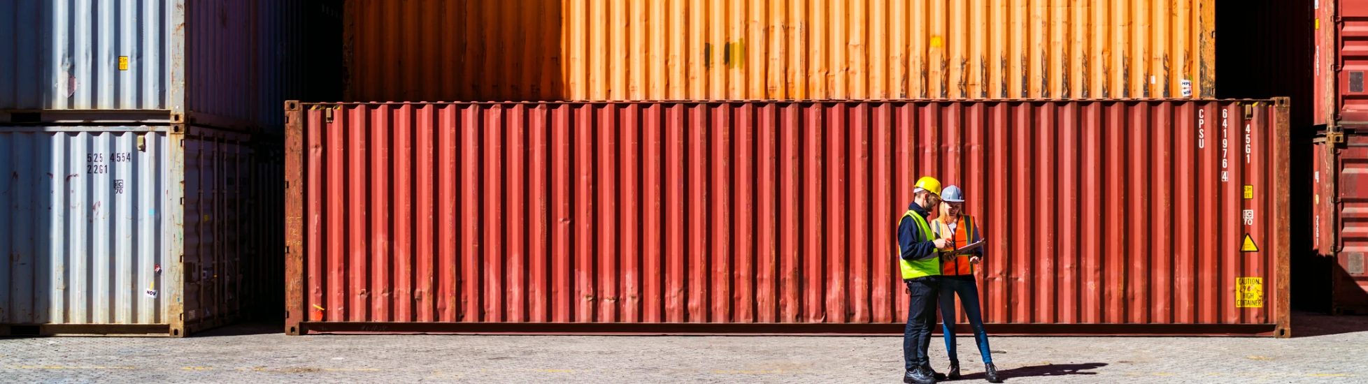 Two workers having a conversation about containers