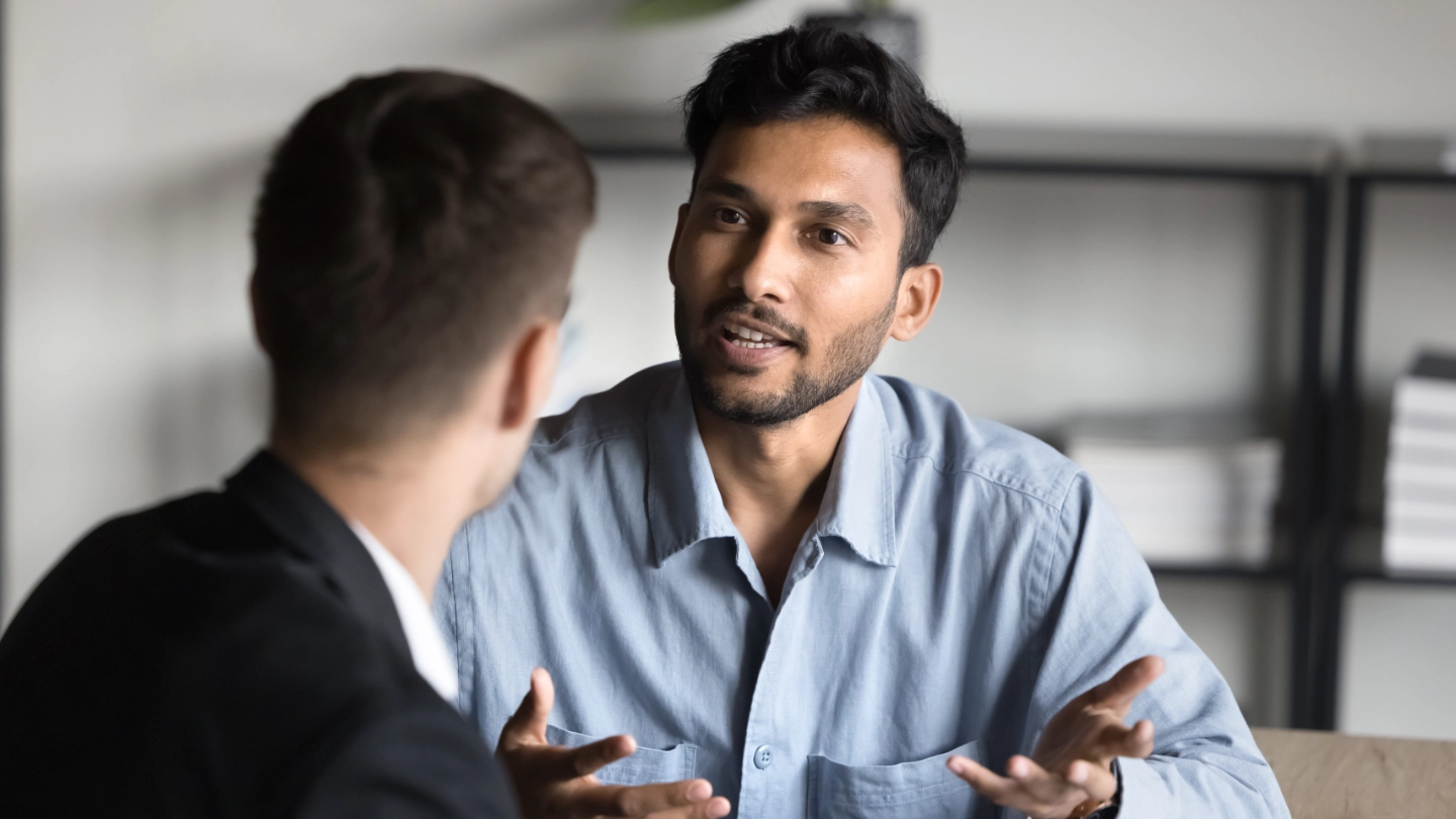 man talking with another man using hands man talking with another man using hands