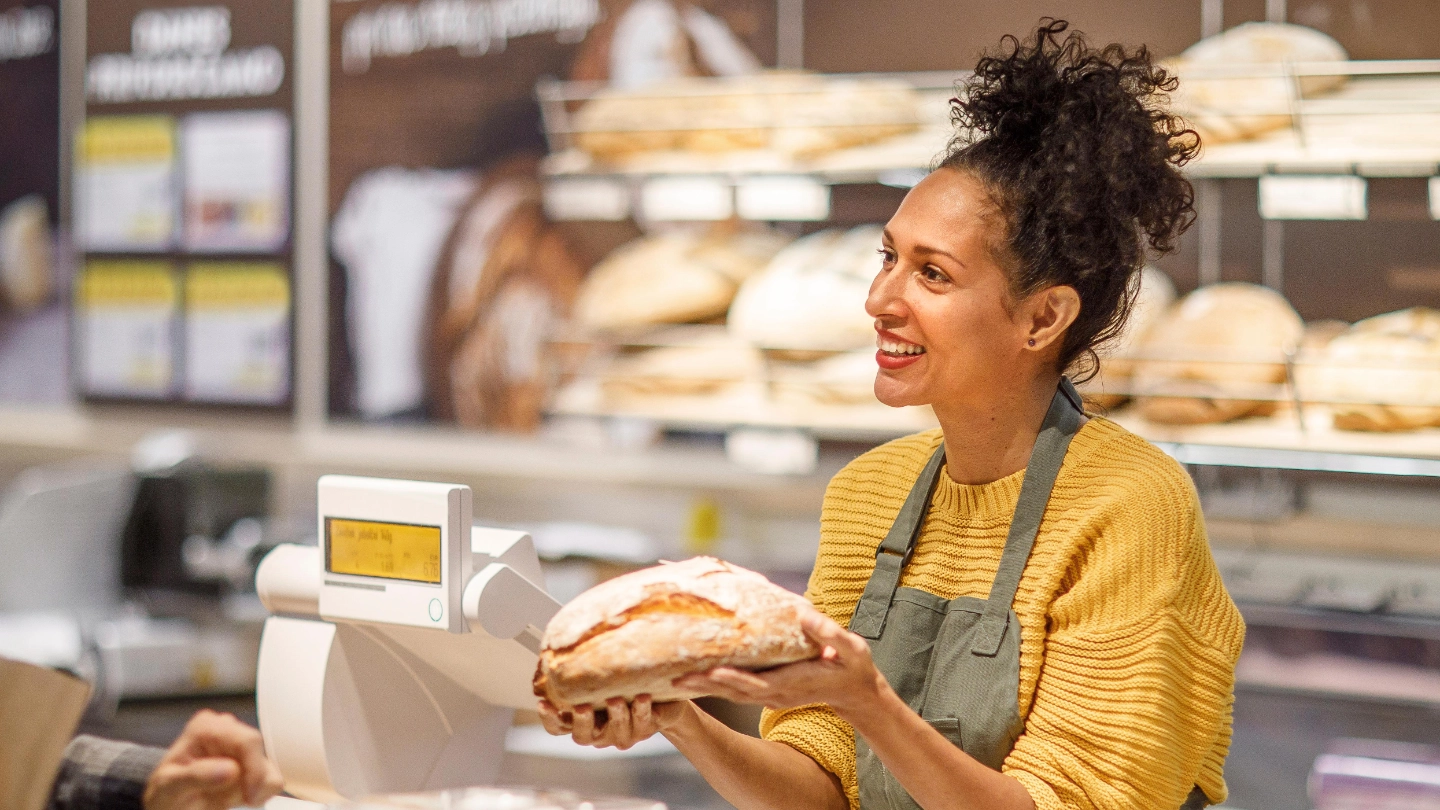 Woman selling bread at a bakery