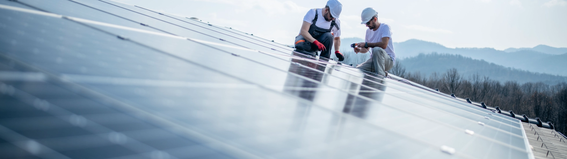 Two engineers installing solar panels